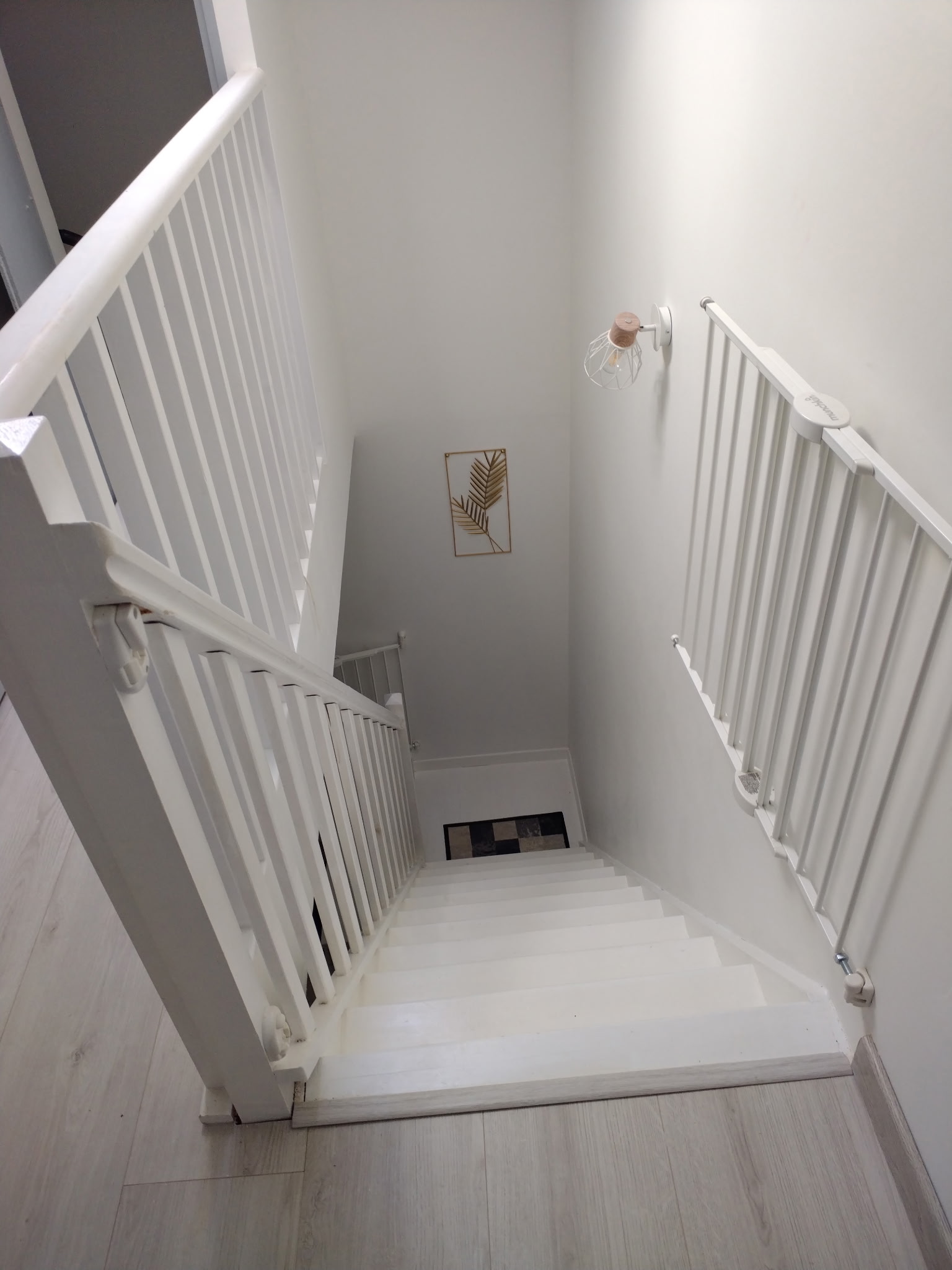 Cage d'escalier menant à l'étage avec barrière enfant